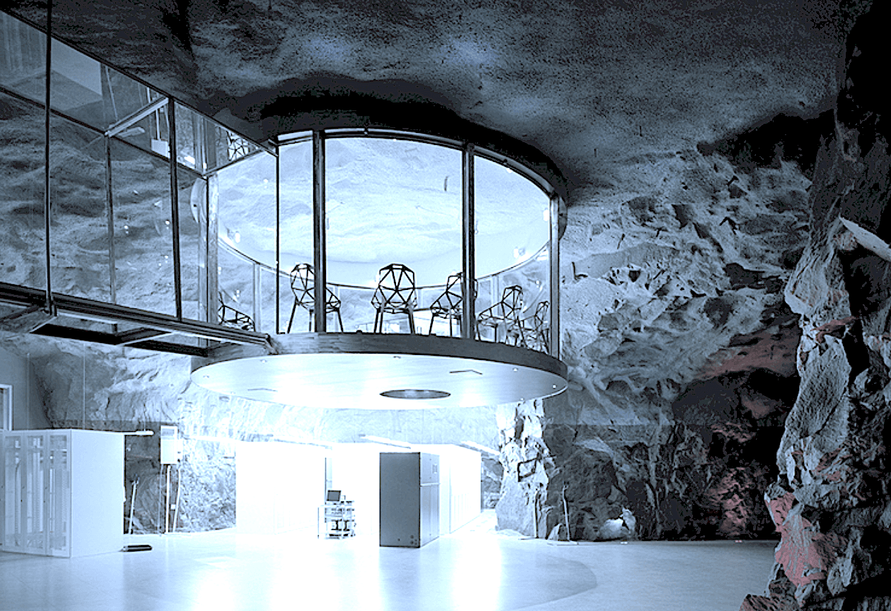 Conference room inside the Pionen White Mountain bunker in Stockholm. Former Cold War nuclear shelter converted into a secure meeting space with exposed granite bedrock walls and futuristic design elements.